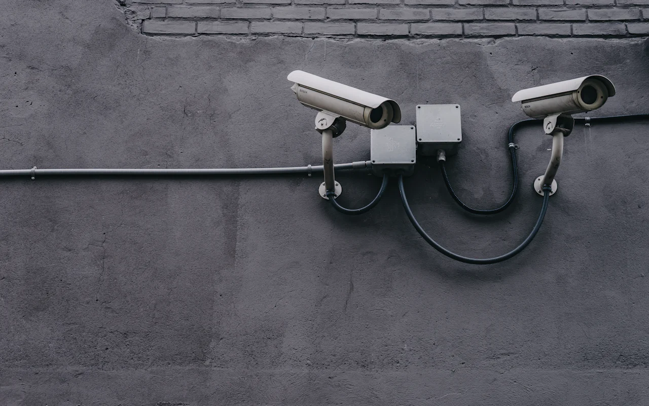 Dos cámaras profesionales de videovigilancia instaladas en el exterior de un edificio.